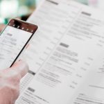 Cliente consultando la carta de un restaurante con un móvil